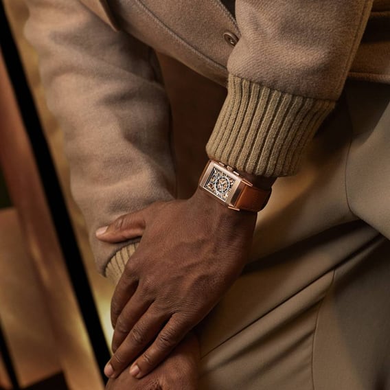 Man wearing a Jaeger-LeCoultre Reverso Tribute Chronograph Gold watch on the back side of the base -  Q389256J