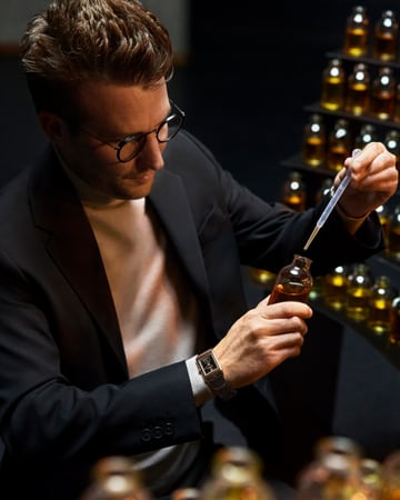 Made of Makers, the French Perfumer Nicolas Bonneville, blending a fragrance creation for Jaeger-LeCoultre and wearing a watch, a Reverso Tribute Monoface Small Seconds black dial, Q713257J