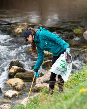 Jaeger-LeCoultre employee cleaning a river