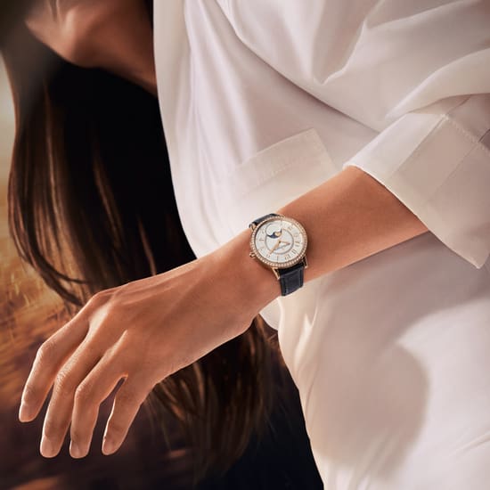 Worn asset by a women wearing a white shirt of the Rendez-Vous Moon, Jaeger-LeCoultre women watch  - Q3572430